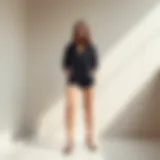 A stylish black shorts onesie on a minimalist background